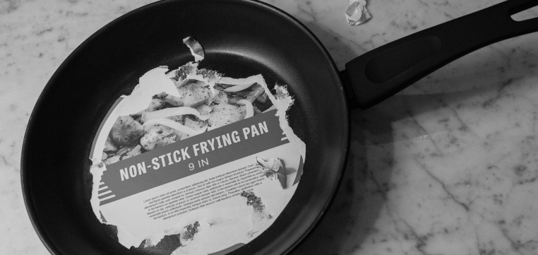 Non-stick frying pan with adhesive label stuck on