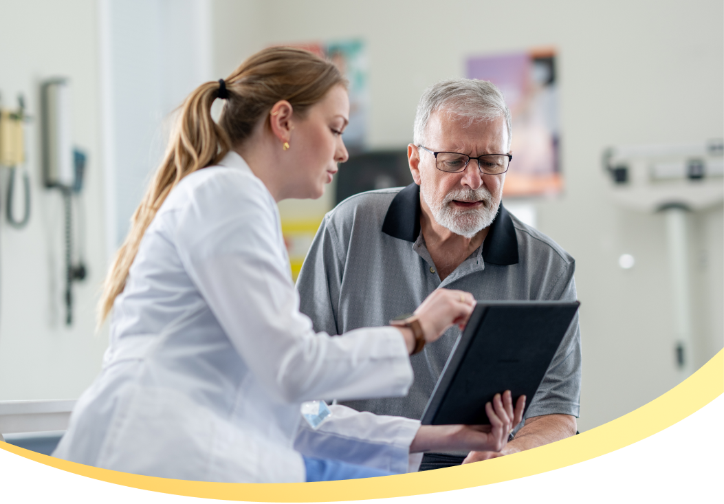 Doctor and patient reviewing tablet in an exam room